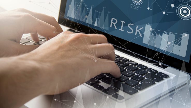 technology and business concept: man using a laptop with risk on the screen. All screen graphics are made up.